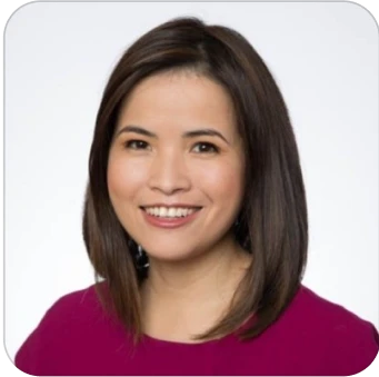 Smiling woman with shoulder-length dark hair in a magenta top against a plain background.