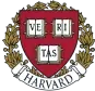 Harvard University emblem featuring the motto "Veritas" on a shield with laurel leaves.